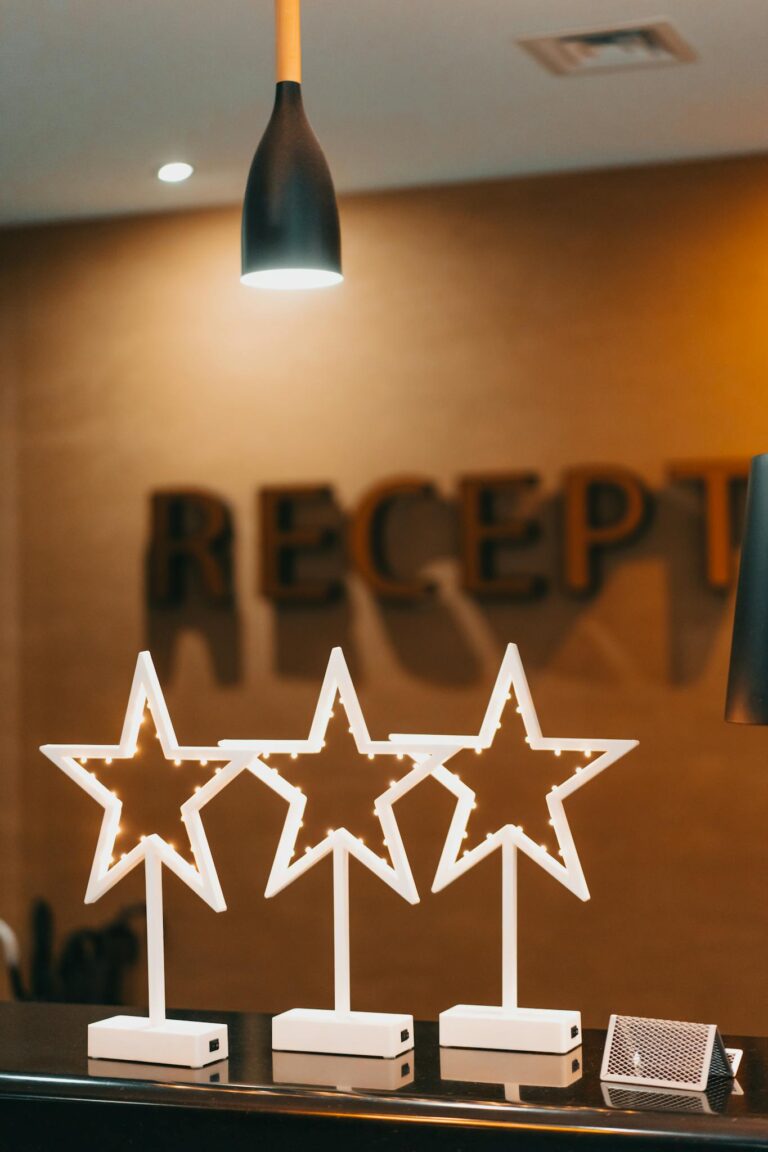 Elegant hotel reception desk featuring modern star-shaped decorations and sleek lighting.