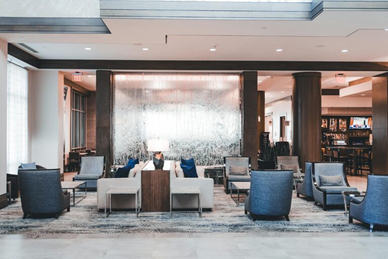 Spacious modern hotel lobby with elegant seating, perfect for relaxation and socializing.